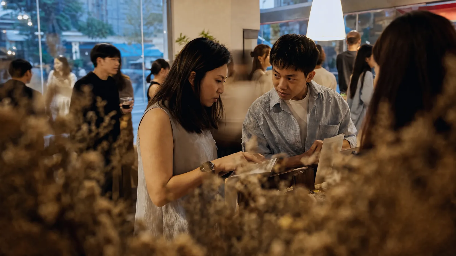 Two firm owners leaning in over material samples, mid-conversation