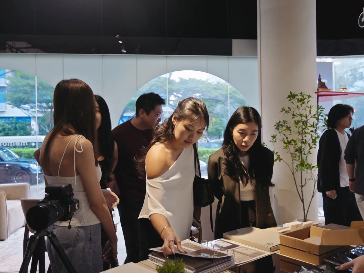 Design firm owners and guests gathered in a showroom