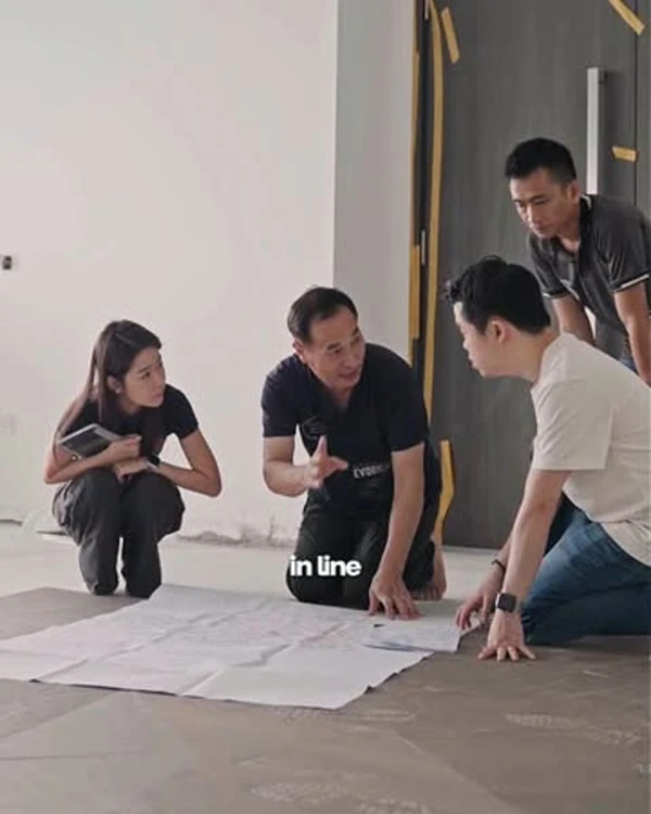 Reel thumbnail: three people reviewing drawings on a site floor