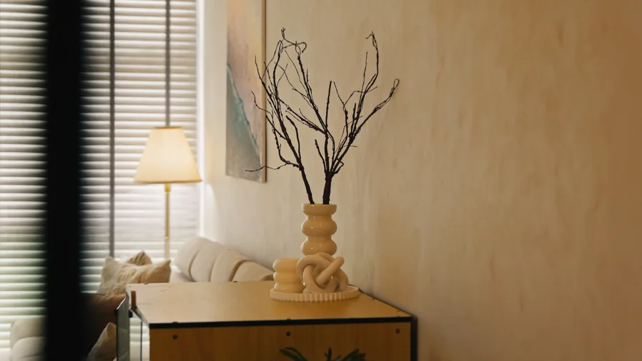 Living room with a textured wall finish and a sculptural vase