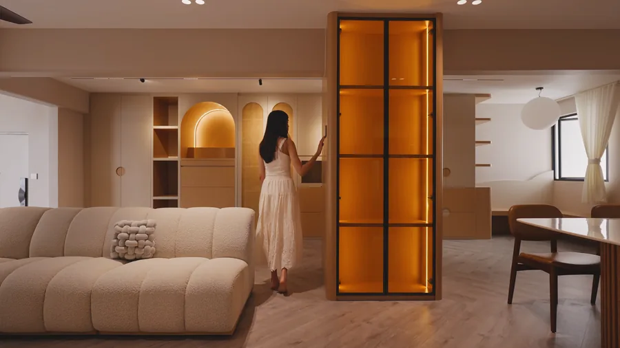 A homeowner at a backlit display cabinet